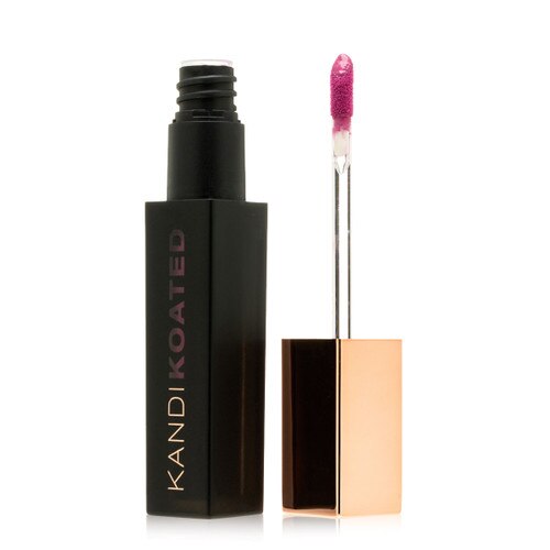 A black rectangular tube of matte lip color next to its rose gold cap and doe foot applicator. The color visible on the applicator and through the tube is Arm Candy, a deep warm pinkish purple.